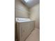 Laundry room equipped with washer, dryer, and overhead wire shelf at 12016 Villanova Dr # 102, Orlando, FL 32837