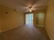 Bright living room with carpet, ceiling fan, and sliding glass doors to the outside at 12016 Villanova Dr # 102, Orlando, FL 32837