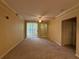 Bright living room with carpet, ceiling fan, and sliding glass doors to the outside at 12016 Villanova Dr # 102, Orlando, FL 32837