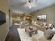 Inviting living room with neutral tones, ceiling fan, and an open concept dining and kitchen area at 12016 Villanova Dr # 102, Orlando, FL 32837