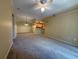 Open-concept living room showcasing the adjacent kitchen and a contemporary ceiling fan at 12016 Villanova Dr # 102, Orlando, FL 32837