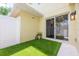Outdoor area featuring artificial turf, a white privacy fence, and a sliding glass door at 13028 Auburn Cove Ln, Orlando, FL 32828