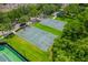 Aerial view of basketball courts with green surfaces and lush landscaping at 13028 Auburn Cove Ln, Orlando, FL 32828
