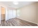 Neutral bedroom with wood-look flooring, double closet, and a window with natural light at 13028 Auburn Cove Ln, Orlando, FL 32828
