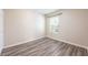 Neutral bedroom with wood-look flooring, a window with natural light and closet at 13028 Auburn Cove Ln, Orlando, FL 32828