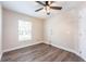 A clean and simple bedroom design featuring neutral walls, new floors, and a ceiling fan at 13028 Auburn Cove Ln, Orlando, FL 32828