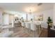 Open-concept dining area adjacent to the kitchen, complete with modern lighting and stylish decor at 13028 Auburn Cove Ln, Orlando, FL 32828