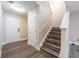Inviting entryway featuring wood-look flooring, staircase and a front door for easy access at 13028 Auburn Cove Ln, Orlando, FL 32828