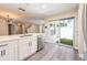 Open kitchen featuring stainless steel appliances, white cabinets, quartz countertops, and outdoor access at 13028 Auburn Cove Ln, Orlando, FL 32828
