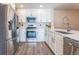 Modern kitchen boasting stainless steel appliances, white cabinetry, and quartz countertops at 13028 Auburn Cove Ln, Orlando, FL 32828