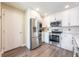 Contemporary kitchen with stainless steel appliances, white cabinetry, and modern finishes at 13028 Auburn Cove Ln, Orlando, FL 32828