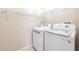 Convenient laundry room includes modern washer and dryer units and wire shelving at 13028 Auburn Cove Ln, Orlando, FL 32828