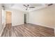 Spacious main bedroom boasting new flooring, a tray ceiling with fan, and access to an en-suite bathroom at 13028 Auburn Cove Ln, Orlando, FL 32828