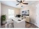Bright home office with modern desk, stylish decor, and ample natural light at 13028 Auburn Cove Ln, Orlando, FL 32828