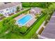Aerial view of the community pool with lounge chairs and a covered pavilion at 13028 Auburn Cove Ln, Orlando, FL 32828