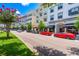 A picturesque street view showcases the vibrant storefronts and colorful cars lining the charming commercial district at 13028 Auburn Cove Ln, Orlando, FL 32828