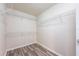 Walk-in closet with installed wire shelving and wood-look flooring for organized storage solutions at 13028 Auburn Cove Ln, Orlando, FL 32828