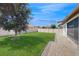 Beautiful backyard with lush green grass, mature tree, and privacy fence at 14124 Dove Hollow Dr, Orlando, FL 32824