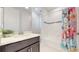 Bathroom featuring a large vanity, white countertops, and a tub-shower with a fun shower curtain at 14124 Dove Hollow Dr, Orlando, FL 32824