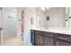 Bright bathroom with a dark vanity, white countertops, and a colorful shower curtain at 14124 Dove Hollow Dr, Orlando, FL 32824