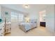 Bedroom with a large window, an ensuite bathroom and neutral tones at 14124 Dove Hollow Dr, Orlando, FL 32824