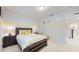 Bedroom with a yellow stripe accent wall, a decorative headboard, and an open doorway at 14124 Dove Hollow Dr, Orlando, FL 32824