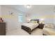 Bedroom with a yellow stripe accent wall, stylish lamps, and neutral colors at 14124 Dove Hollow Dr, Orlando, FL 32824