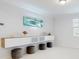 Modern bonus room features a floating media console and four comfy ottomans at 14124 Dove Hollow Dr, Orlando, FL 32824