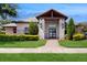 Community clubhouse with stone facade, manicured landscaping, and inviting entrance at 14124 Dove Hollow Dr, Orlando, FL 32824