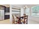 Bright dining area features a modern chandelier, tile flooring and built-in shelving, enhancing the space's appeal at 14124 Dove Hollow Dr, Orlando, FL 32824