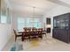 Elegant dining room with a wooden table, seating for eight, and natural light from the windows at 14124 Dove Hollow Dr, Orlando, FL 32824