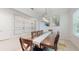 Bright dining room with decorative wall features, a long wood table, and neutral-toned flooring at 14124 Dove Hollow Dr, Orlando, FL 32824