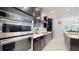 Well-equipped kitchen with modern appliances, sleek countertops, and views into the dining area at 14124 Dove Hollow Dr, Orlando, FL 32824