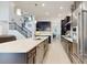 Open-concept kitchen with stainless appliances, a large island, dark cabinets, and access to dining and living spaces at 14124 Dove Hollow Dr, Orlando, FL 32824