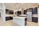 Modern kitchen with dark cabinets, stainless steel appliances, a white island, and recessed lighting at 14124 Dove Hollow Dr, Orlando, FL 32824