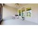 Covered lanai features neutral finishes, an outdoor ceiling fan and multiple windows for outdoor enjoyment at 14124 Dove Hollow Dr, Orlando, FL 32824