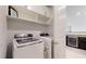 Convenient laundry room featuring modern appliances and ample storage space at 14124 Dove Hollow Dr, Orlando, FL 32824