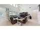 Bright living room with high ceilings, stylish furniture, and large windows allowing ample natural light at 14124 Dove Hollow Dr, Orlando, FL 32824