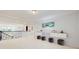 Bright loft with white walls, contemporary decor, and wrought iron stair railing overlooking the living area at 14124 Dove Hollow Dr, Orlando, FL 32824