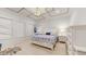 Bright bedroom with white walls, tray ceiling detail, a patterned rug, and bedside tables at 14124 Dove Hollow Dr, Orlando, FL 32824
