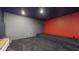Finished media room features dark carpet, red accent wall, and tiered seating at 14124 Dove Hollow Dr, Orlando, FL 32824