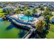 Aerial view of community pool with lake access and palm tree landscaping at 14124 Dove Hollow Dr, Orlando, FL 32824