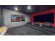 Entertainment goals are achieved with this theater room showcasing stadium seating and a large projection screen at 14124 Dove Hollow Dr, Orlando, FL 32824