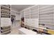 Well-organized walk-in closet offers ample shelving, drawers, and hanging space for efficient storage at 14124 Dove Hollow Dr, Orlando, FL 32824