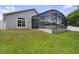 A well-maintained lawn leads up to a screened in pool and patio area at 1542 Wescott Loop, Winter Springs, FL 32708