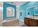 Well-lit bathroom with a sunken tub, separate shower, tile flooring, and a large vanity with dual sinks at 1542 Wescott Loop, Winter Springs, FL 32708