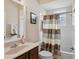 Cozy bathroom featuring a shower-tub combo, white tile, and vanity with sink at 1542 Wescott Loop, Winter Springs, FL 32708