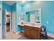 Bathroom featuring a sink vanity with makeup area, large mirrors, and a glimpse of an adjacent bedroom at 1542 Wescott Loop, Winter Springs, FL 32708
