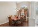 Formal dining room with hardwood floors, large arched window, stylish light fixture and seating for six at 1542 Wescott Loop, Winter Springs, FL 32708