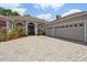 Beautiful home featuring manicured landscaping, a brick driveway, and a spacious three-car garage at 1542 Wescott Loop, Winter Springs, FL 32708
